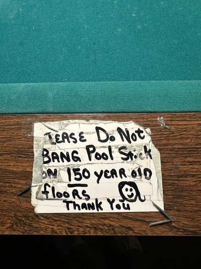Warning sign on pool table